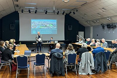 Brian chairing a health meeting