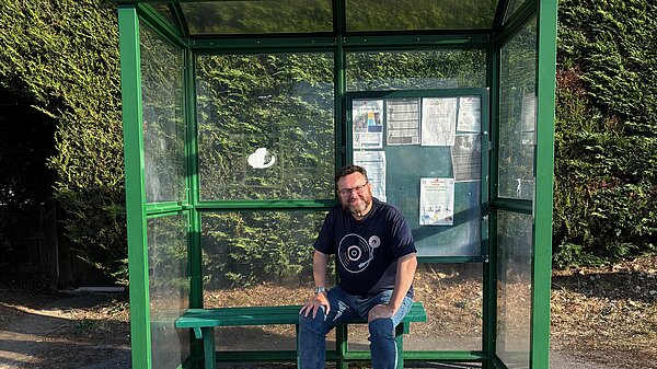 Phil Chamberlain at a bus stop