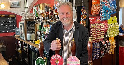 Brian pulling a pint at a pub