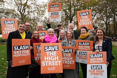 Lib Dem MPs holding placards saying 'Save our high street'