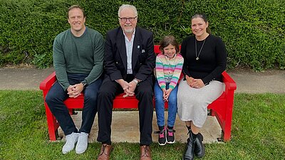 Brian with Amalie and her family in Broughton Gifford for the unveiling of a red bench in her name